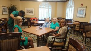 Reporter Liz Bonis, The Kenwood program and events manager Annette DeCamp and residents Margaret and Edith