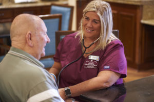 A Senior Star resident meets with a caregiver about his medication fall risk