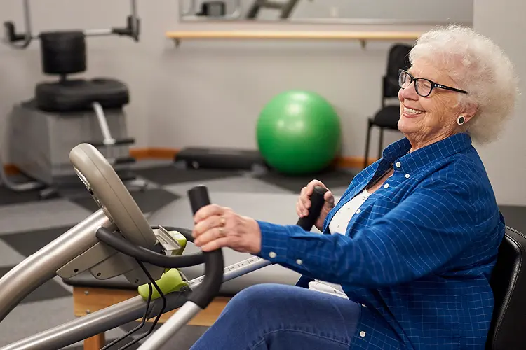 an elderly woman on a shapemaster machine