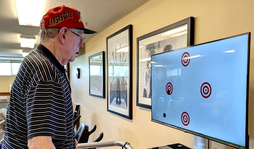 a man on a treadmill watching a screen