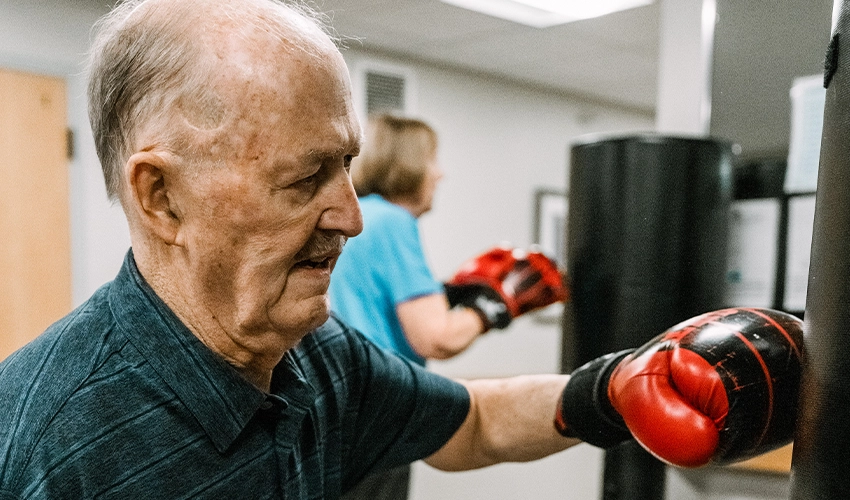 a man boxing in the rock sterady boxing program