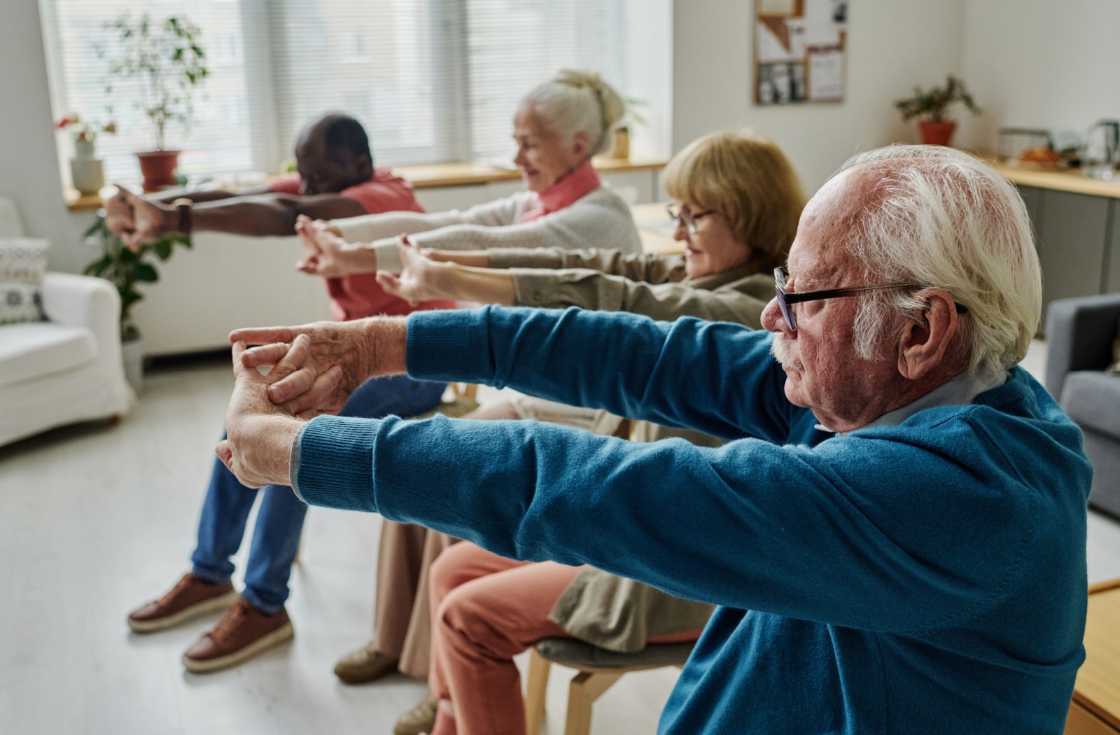 A group of seniors participate in an exercise class together
