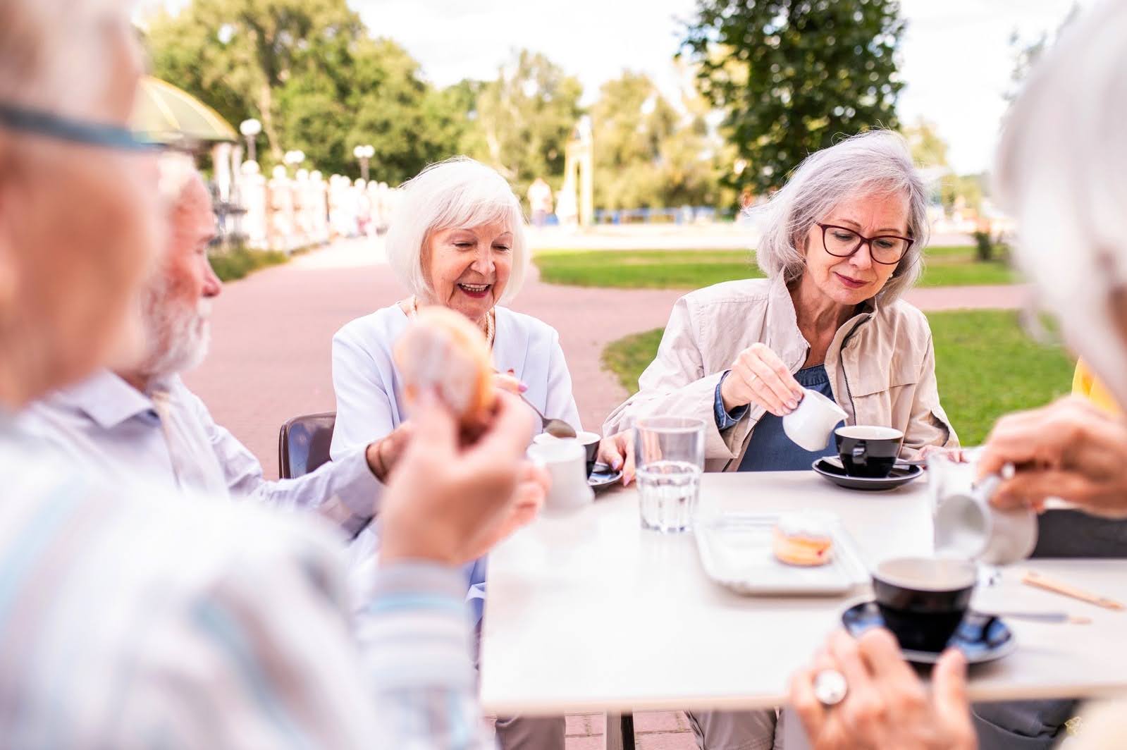 Older adults having fun and spending time together outside and having coffee.