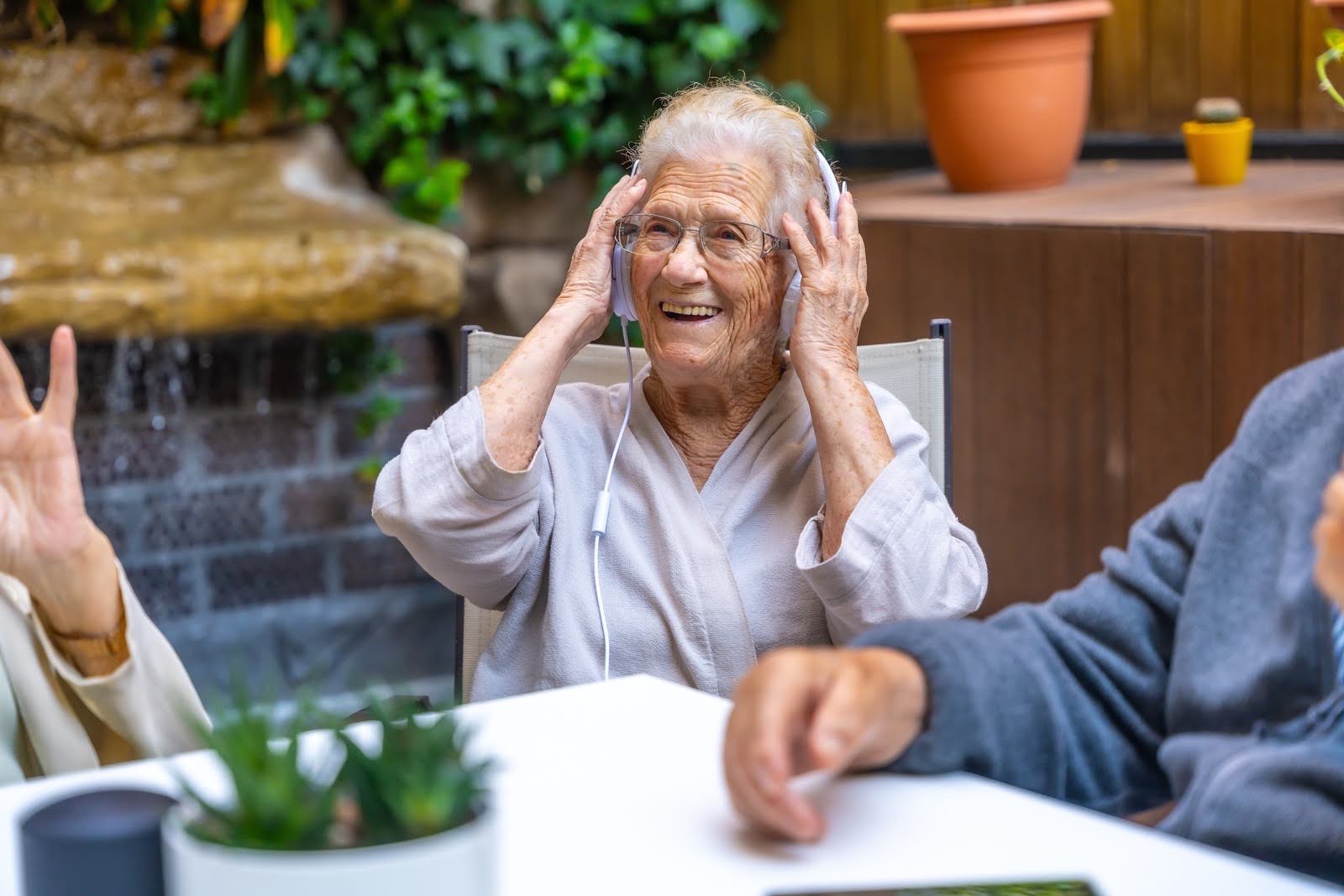 Happy seniors using headphones and having fun